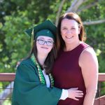 Women with Down Syndrome in graduation gown.