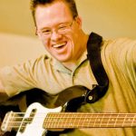 Person with Down Syndrome playing Guitar.